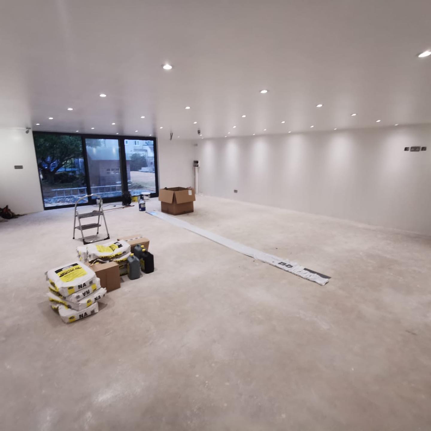 Inside newly built empty and bright summer house with spot lights