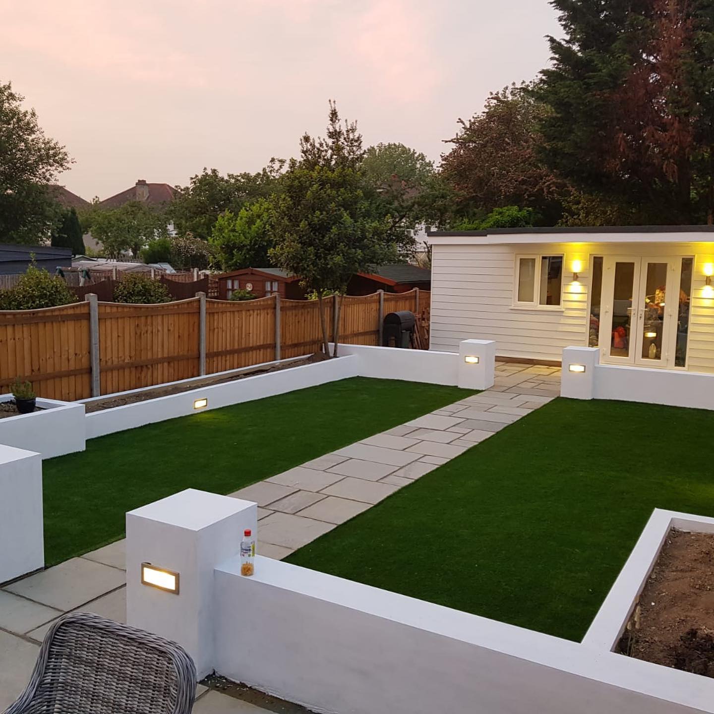 New garden landscape with white surrounding walls and a white summer house