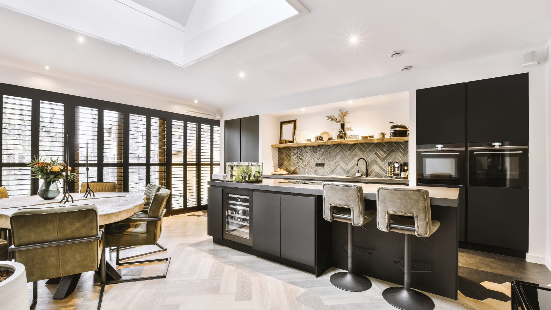 modern black kitchen units in a white kitchen and dining area